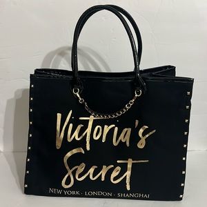 Victoria’s Secret black and gold tote bag with chain and studs.